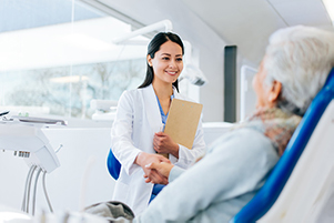 Doctor greeting patient sitting in dental chair at Peak Endodontics in Covington, WA