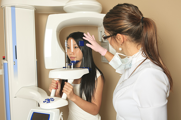 Doctor examining patient with cone beam